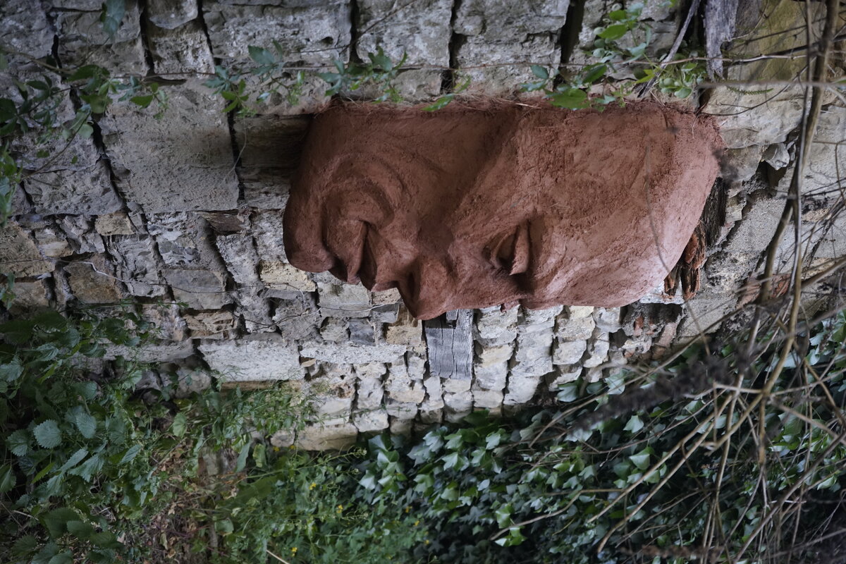 Semiostalgia P0013 — Sculpture fraîche, en terre crue, sable, filasse végétale, paille, grillage à poule, sur mur de pierre calcaire, Saint-Antonin-Noble-Val